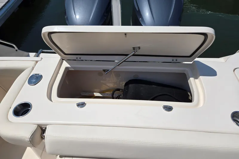 Slide: The Image of 2016 Grady-White Freedom 307 boat storage compartment open, showing interior space. - 9