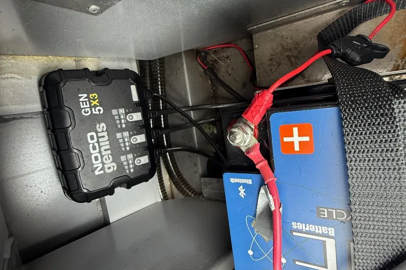 Slide: The Image of NOCO Genius GEN5X3 charger connected to a battery in a 2021 Ranger RT178 boat. - 12