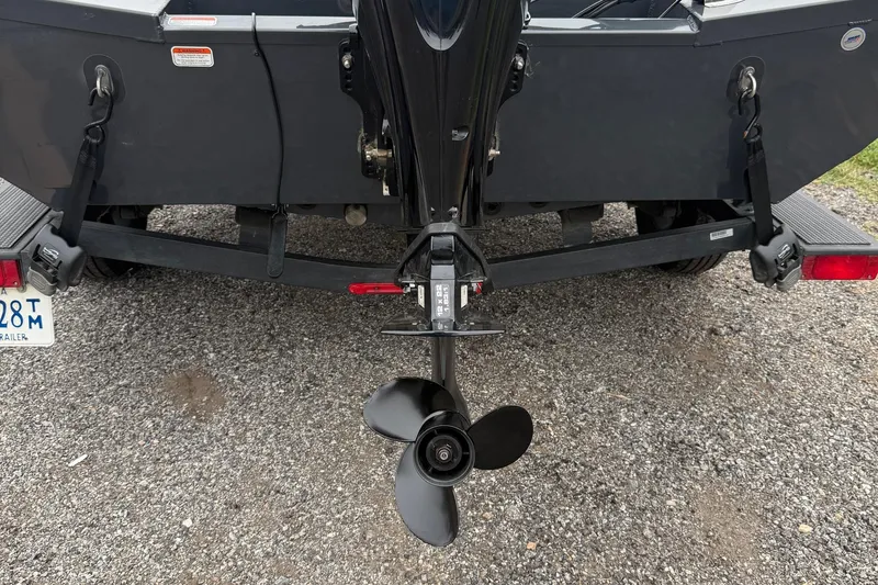 Slide: The Image of Rear view of a 2021 Ranger RT178 boat on a trailer, showing the propeller. - 3