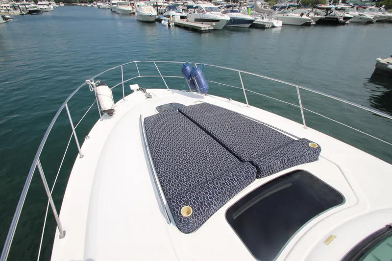 Slide: The Image of 2004 Sea Ray 40 Sundancer yacht with sun pads, docked in a marina. - 15