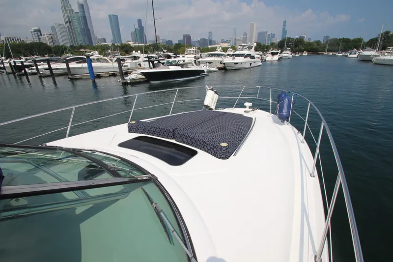 Slide: The Image of 2004 Sea Ray 40 Sundancer yacht docked in a marina with city skyline. - 19