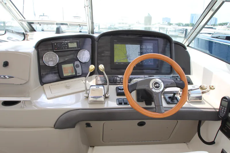 Slide: The Image of Helm of 2004 Sea Ray 40 Sundancer with navigation equipment and wooden steering wheel. - 25
