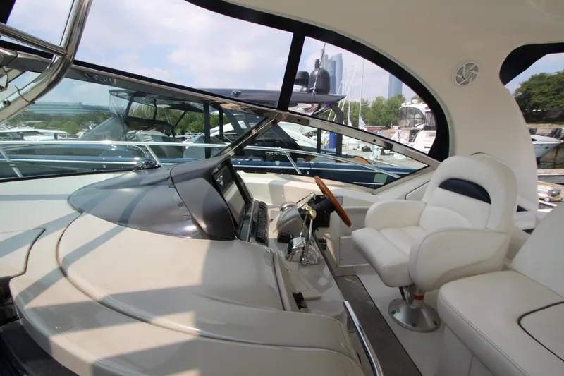 Slide: The Image of 2004 Sea Ray 40 Sundancer yacht interior with helm and seating area. - 26