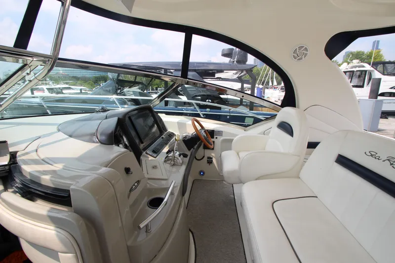 Slide: The Image of 2004 Sea Ray 40 Sundancer helm with luxurious seating and modern controls. - 29