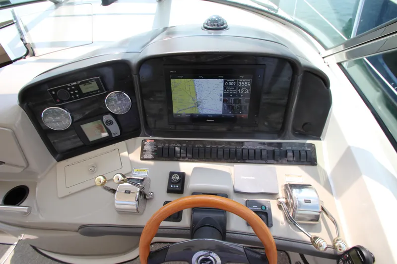 Slide: The Image of 2004 Sea Ray 40 Sundancer helm with navigation controls and steering wheel. - 30