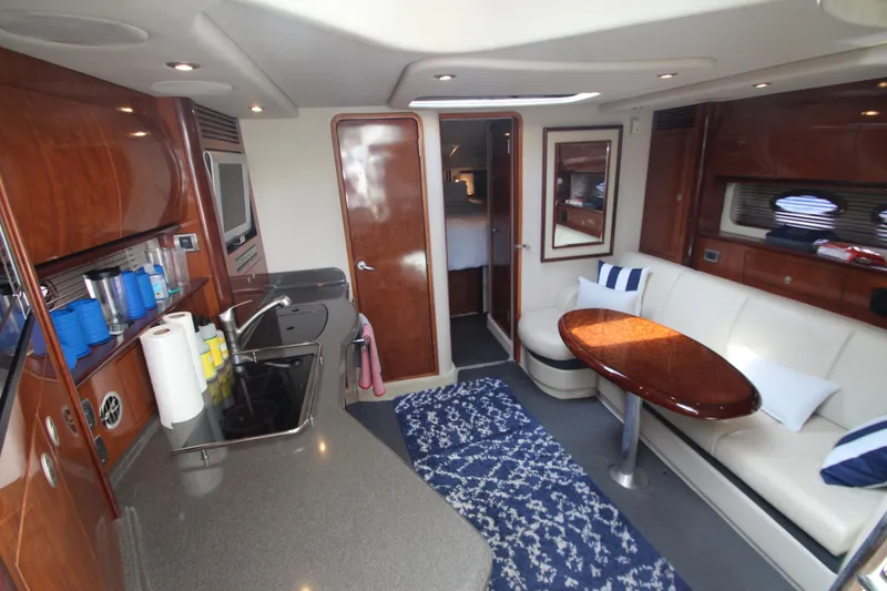 Slide: The Image of Luxurious interior of 2004 Sea Ray 40 Sundancer yacht with modern kitchen and seating area. - 32