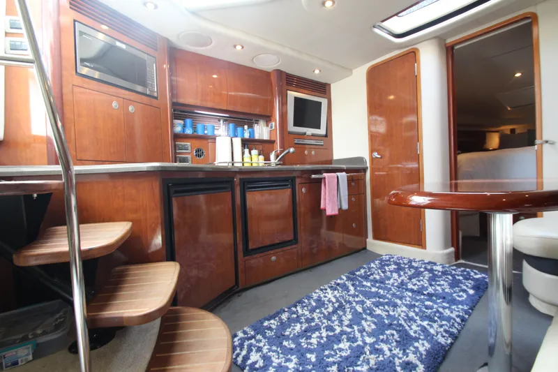 Slide: The Image of Interior of 2004 Sea Ray 40 Sundancer yacht with kitchen and seating area. - 35