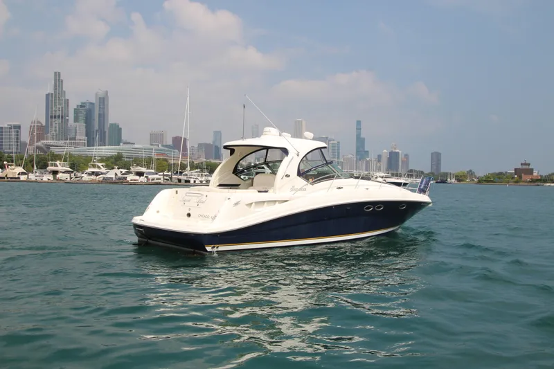 Slide: The Image of 2004 Sea Ray 40 Sundancer yacht on water with city skyline in background. - 4