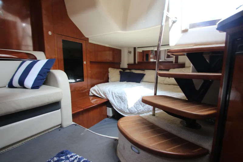 Slide: The Image of Interior of 2004 Sea Ray 40 Sundancer yacht with cozy bed and wooden stairs. - 48