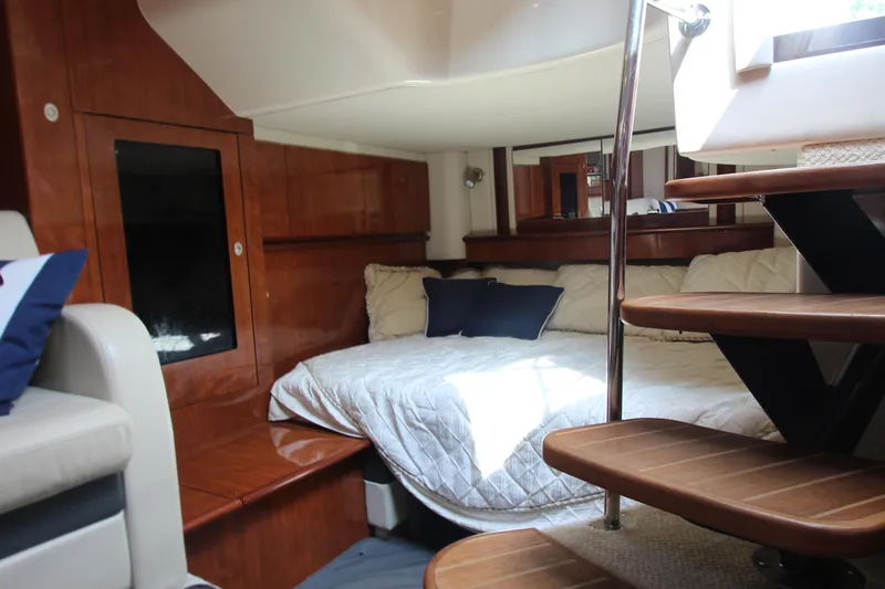 Slide: The Image of Luxurious interior of 2004 Sea Ray 40 Sundancer yacht with cozy bed and wooden stairs. - 49