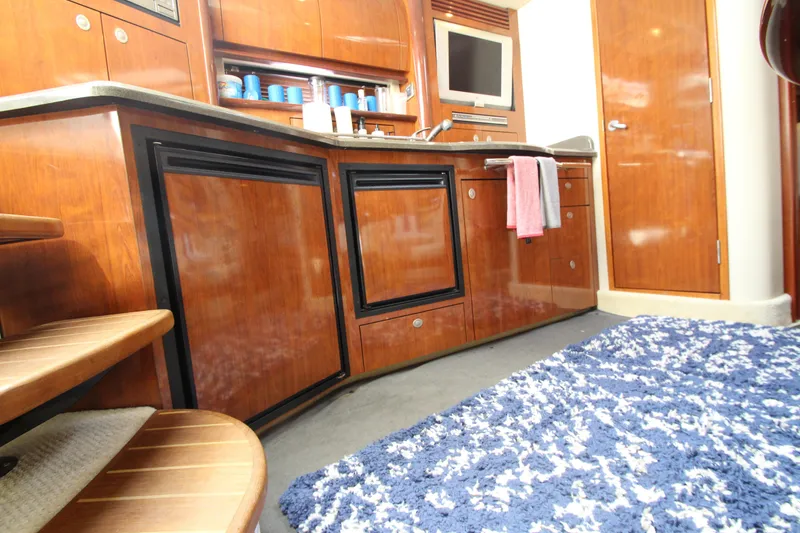 Slide: The Image of Interior of 2004 Sea Ray 40 Sundancer yacht with wooden cabinetry and modern amenities. - 50