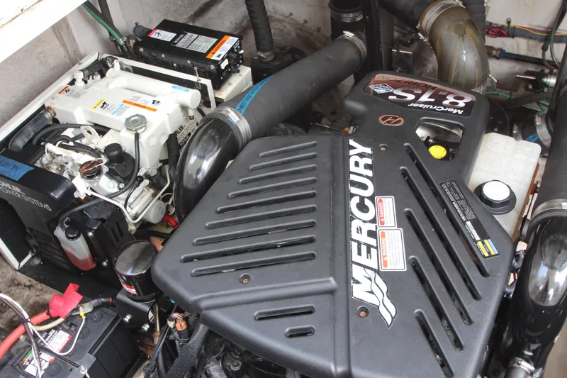 Slide: The Image of Engine compartment of a 2004 Sea Ray 40 Sundancer with Mercury components. - 53