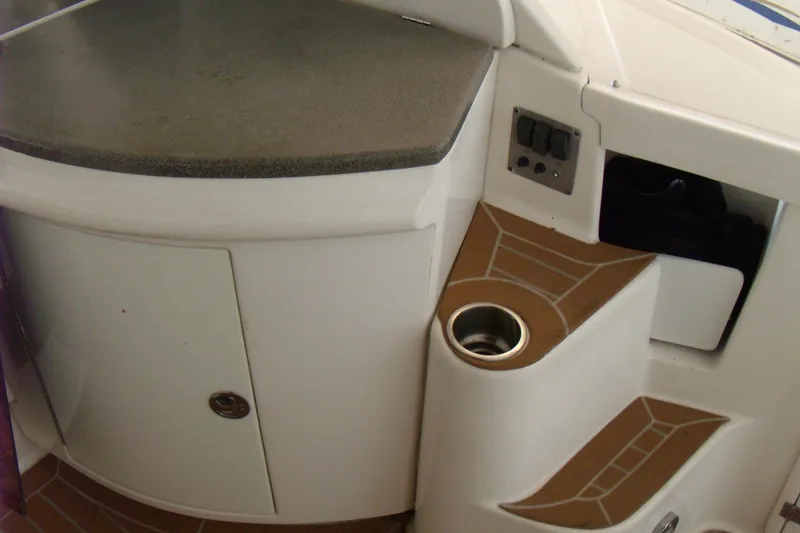 Slide: The Image of 2006 Regal Commodore 4460 boat interior with storage and cup holder. - 12