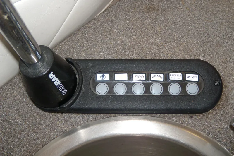 Slide: The Image of Control panel of a 2006 Regal Commodore 4460 boat with labeled buttons for beverages. - 15
