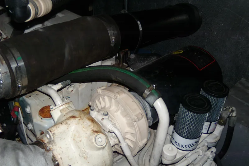 Slide: The Image of Engine compartment of a 2006 Regal Commodore 4460 boat, showing hoses and filters. - 19