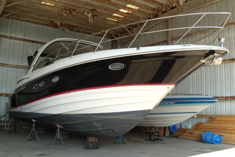 Slide: The Image of 2006 Regal Commodore 4460 yacht in storage, showcasing sleek design and elegant structure. - 2