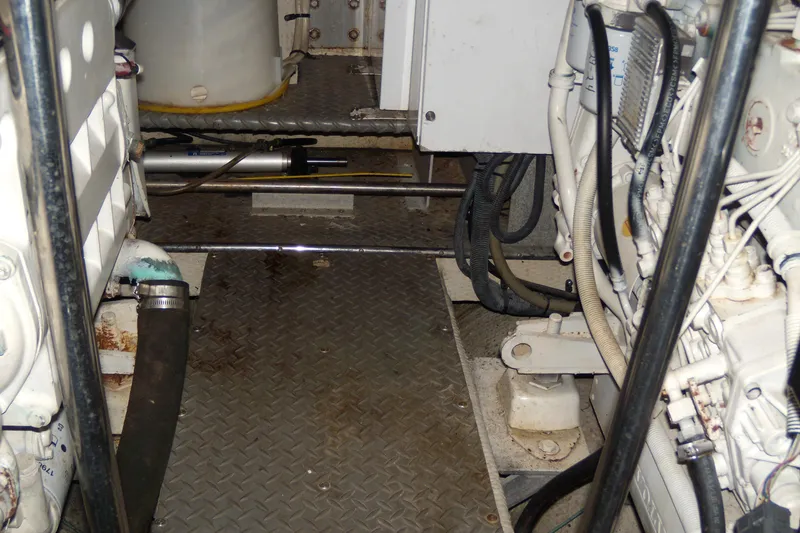 Slide: The Image of Engine room of 2006 Regal Commodore 4460 yacht, featuring mechanical components and piping. - 22