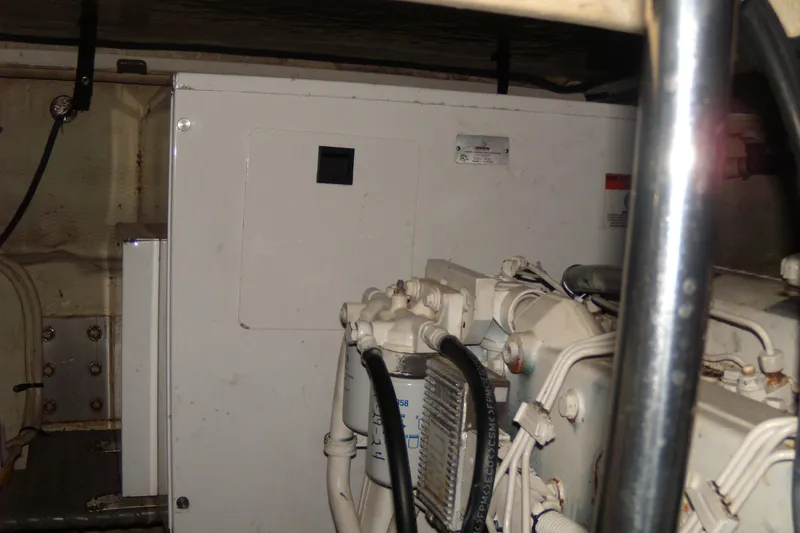 Slide: The Image of Engine room of 2006 Regal Commodore 4460 yacht, showcasing machinery and components. - 23