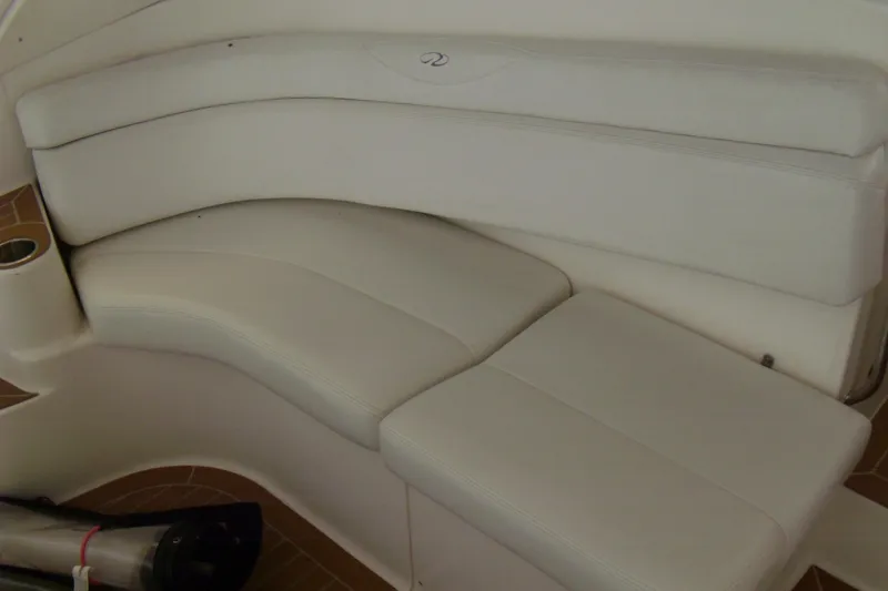 Slide: The Image of 2006 Regal Commodore 4460 boat interior seating with white upholstery. - 25