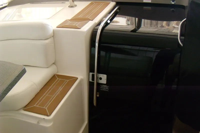 Slide: The Image of Interior of 2006 Regal Commodore 4460 yacht with white seating and sleek design. - 27