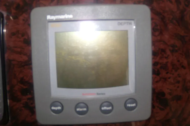 Slide: The Image of Raymarine depth gauge on 2006 Regal Commodore 4460 boat dashboard. - 31