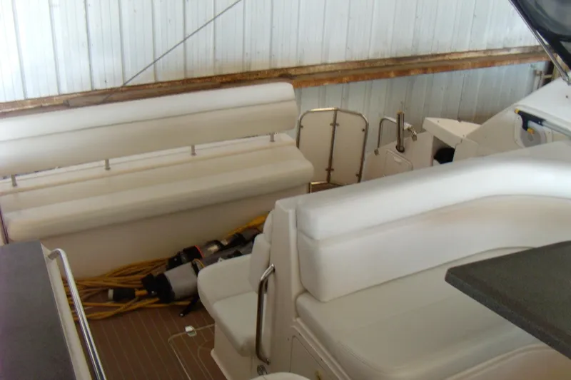Slide: The Image of 2006 Regal Commodore 4460 yacht interior with white seating and wooden flooring. - 34