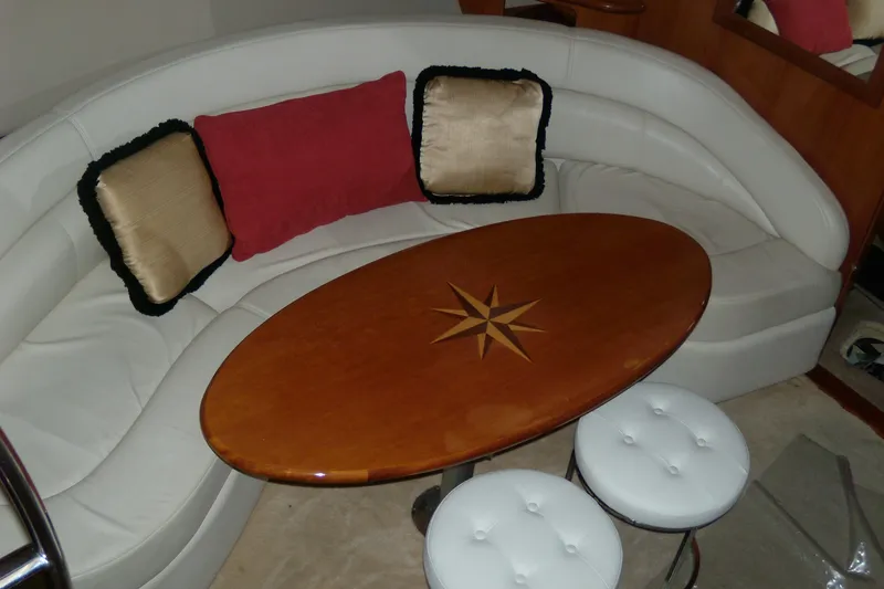 Slide: The Image of Luxurious interior of 2006 Regal Commodore 4460 yacht with elegant seating and wooden table. - 39