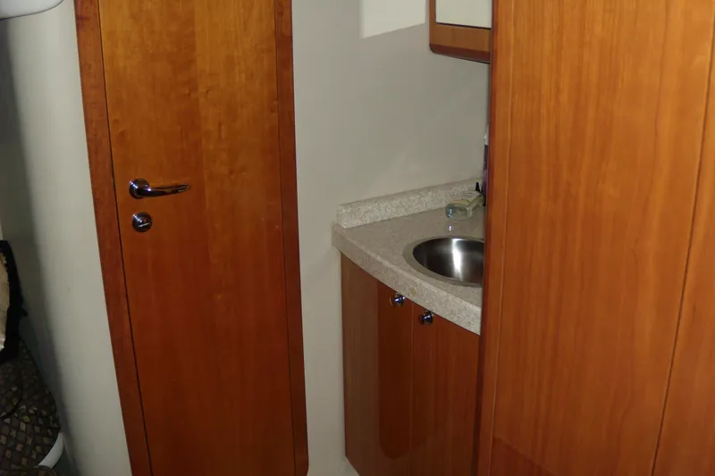 Slide: The Image of 2006 Regal Commodore 4460 yacht interior with wooden cabinetry and compact sink. - 45