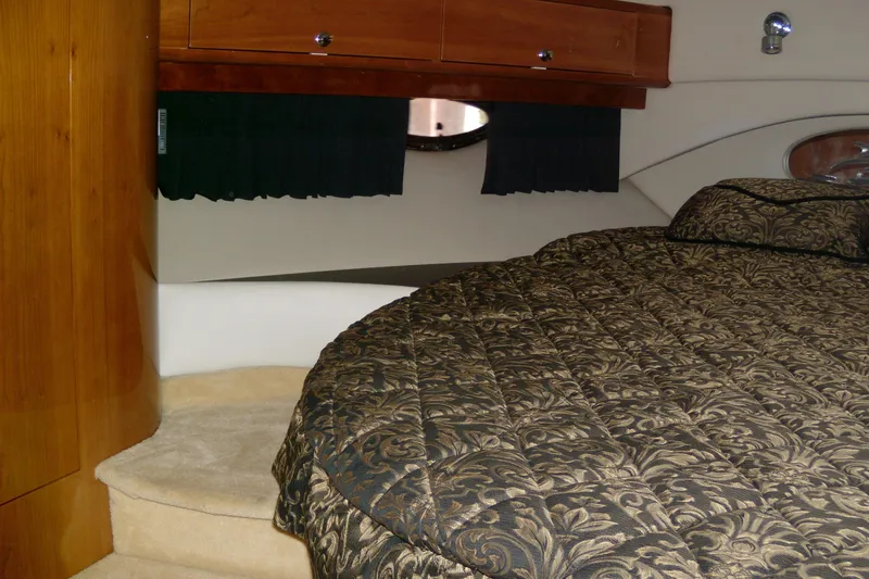 Slide: The Image of Luxurious interior of 2006 Regal Commodore 4460 yacht with elegant bedding and wood accents. - 51