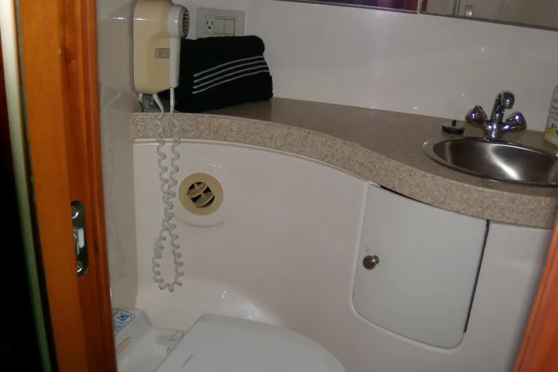 Slide: The Image of Bathroom interior of 2006 Regal Commodore 4460 yacht with sink and hairdryer. - 52