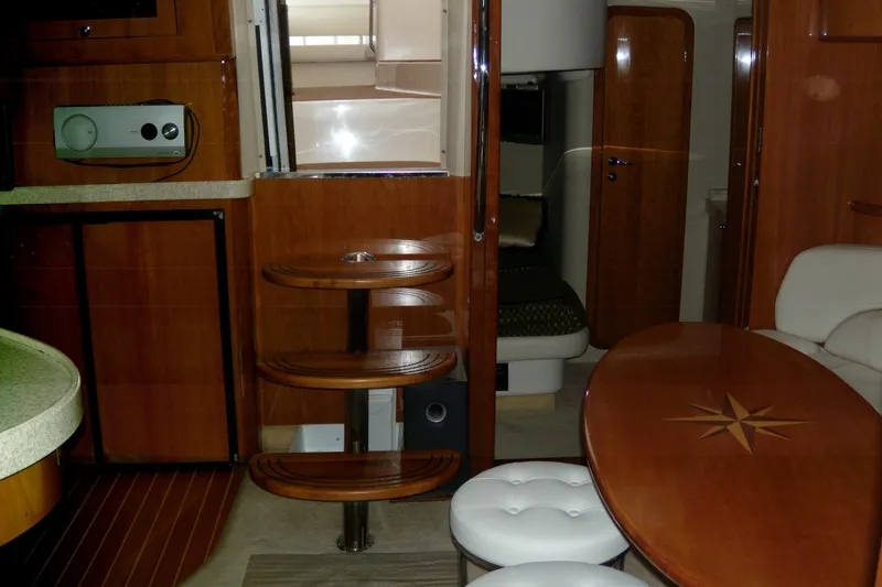 Slide: The Image of Interior of 2006 Regal Commodore 4460 yacht with wooden finishes and seating area. - 53