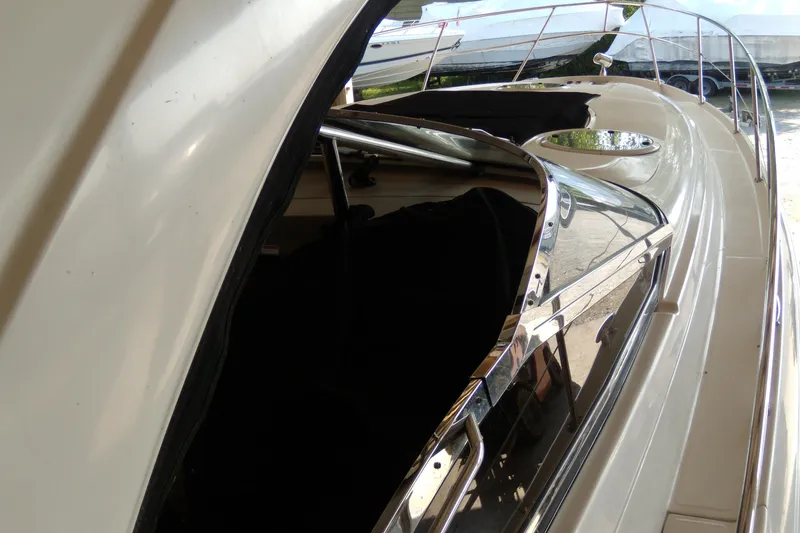 Slide: The Image of 2006 Regal Commodore 4460 yacht, side view with sleek design and chrome accents. - 54