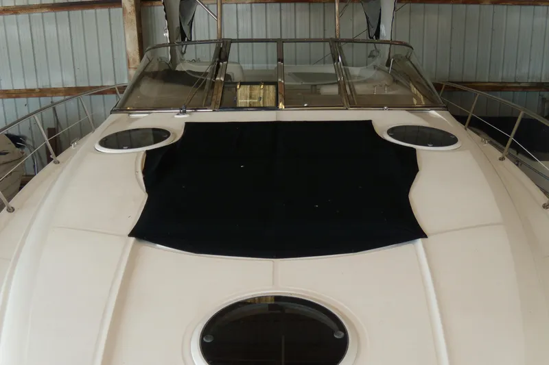 Slide: The Image of 2006 Regal Commodore 4460 yacht in storage, featuring sleek design and spacious deck. - 57