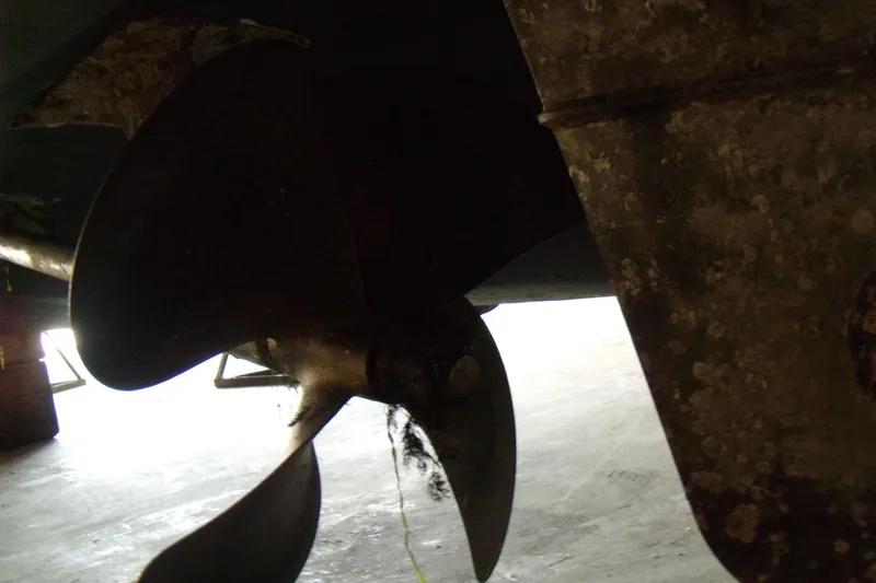 Slide: The Image of Close-up of a 2006 Regal Commodore 4460 boat propeller in a dimly lit setting. - 59