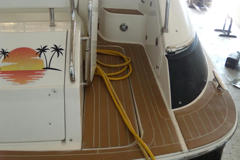 Slide: The Image of 2006 Regal Commodore 4460 boat deck with sunset and palm tree graphic. - 6