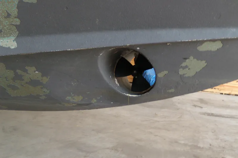 Slide: The Image of Close-up of a 2006 Regal Commodore 4460 boat's bow thruster with peeling paint. - 60