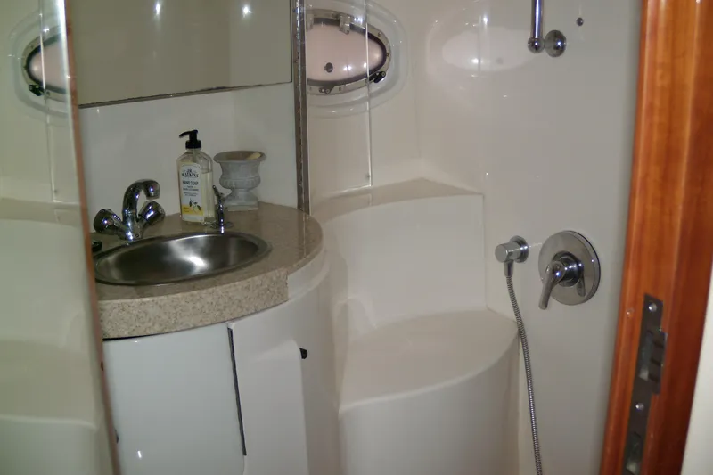 Slide: The Image of 2006 Regal Commodore 4460 yacht bathroom with sink, faucet, and shower controls. - 64
