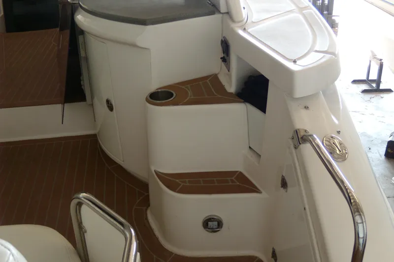 Slide: The Image of 2006 Regal Commodore 4460 boat interior with white seating and wood accents. - 8