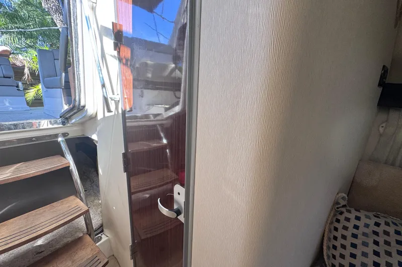 Slide: The Image of Interior view of 2015 Regal 28 Express boat, showing stairs and seating area. - 18