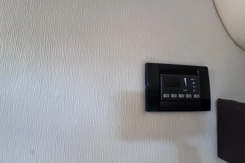 Slide: The Image of Control panel on textured wall inside 2015 Regal 28 Express boat. - 19