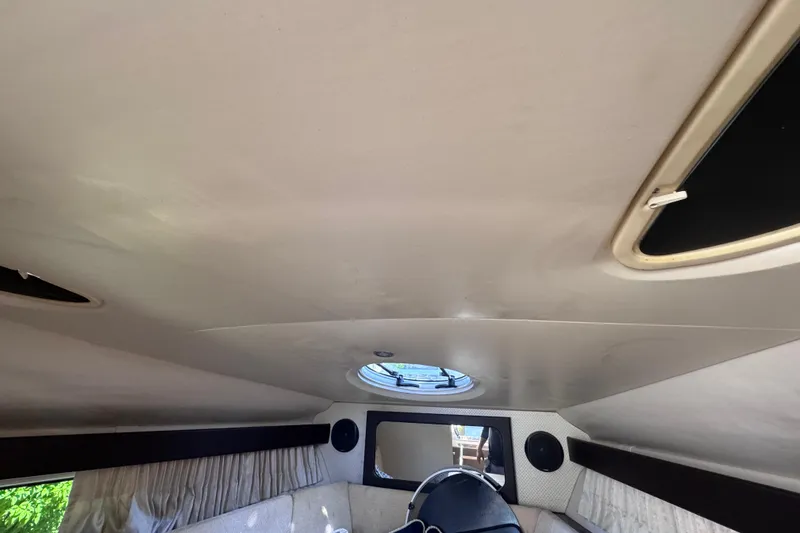 Slide: The Image of Interior cabin of 2015 Regal 28 Express boat with ceiling hatch and curtains. - 20