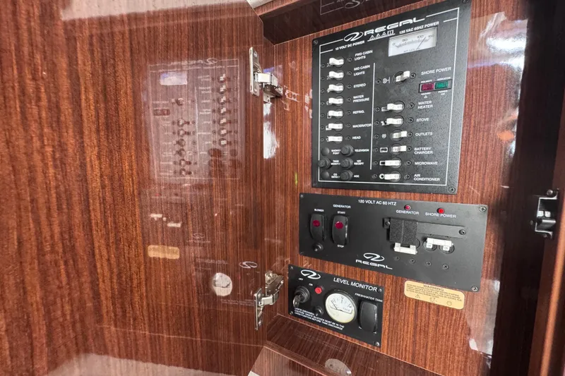 Slide: The Image of Control panel of a 2015 Regal 28 Express boat with wood finish. - 26