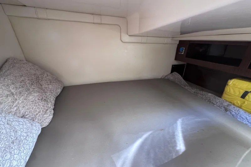 Slide: The Image of 2015 Regal 28 Express cabin interior with bed and storage space. - 34