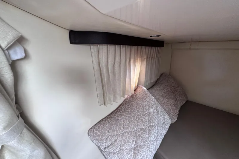 Slide: The Image of Interior cabin of 2015 Regal 28 Express with pillows and curtains. - 37