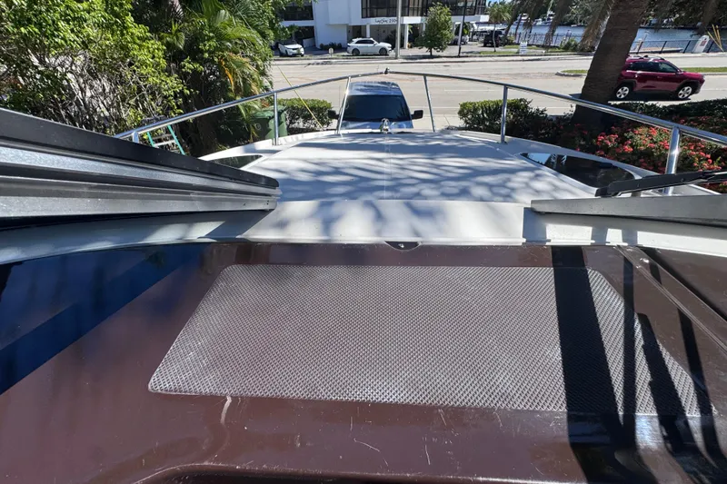 Slide: The Image of 2015 Regal 28 Express boat deck view with railing and urban background. - 43