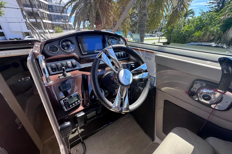 Slide: The Image of 2015 Regal 28 Express boat cockpit with modern steering and control panel. - 54