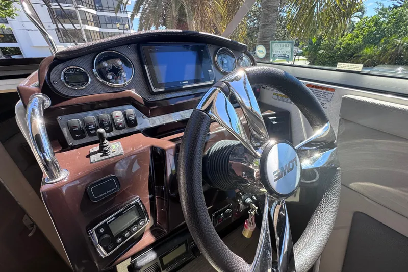 Slide: The Image of Cockpit of 2015 Regal 28 Express boat with modern steering and controls. - 55