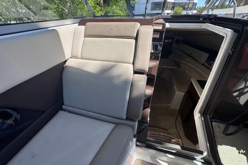 Slide: The Image of 2015 Regal 28 Express boat interior with seating and cabin view. - 57