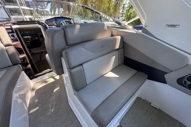 Slide: The Image of 2015 Regal 28 Express boat interior with gray seating and modern dashboard. - 59