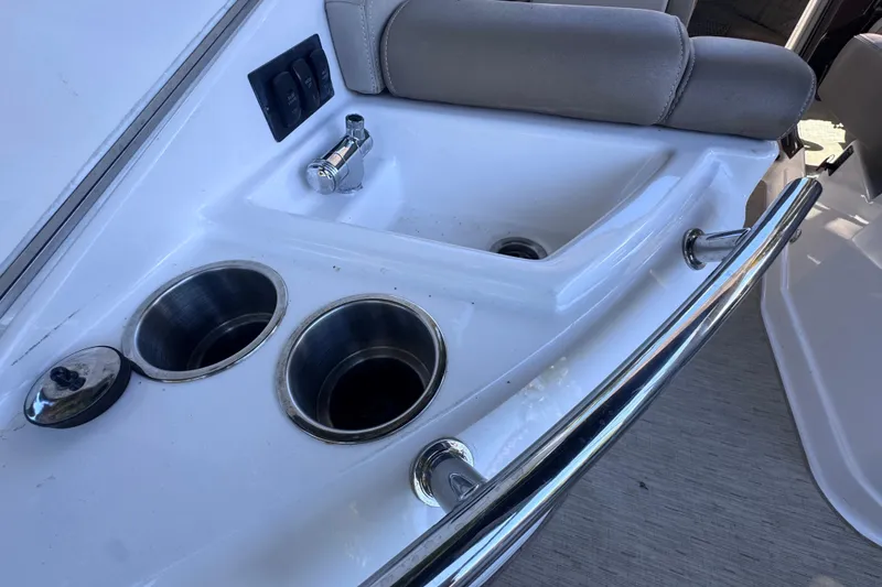 Slide: The Image of 2015 Regal 28 Express boat interior with sink and cup holders. - 62